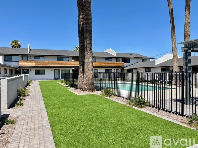 A modern house with a pool and a fence.