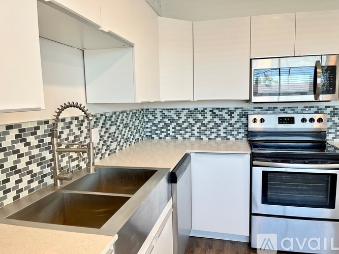 A kitchen with a black and white checkered backsplash.