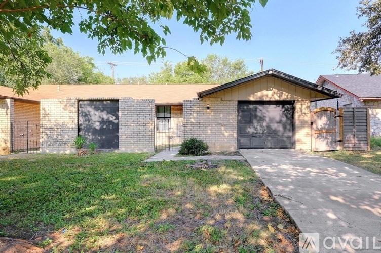 A row of garages with a grassy area in front.