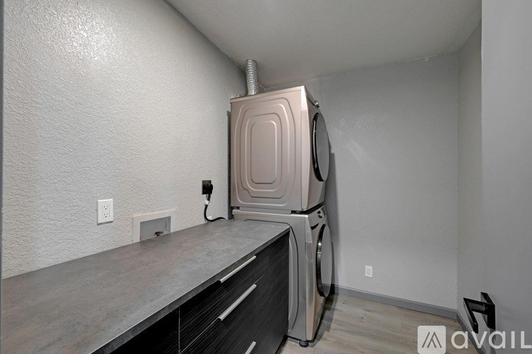 A washer and dryer stacked on top of each other in a laundry room.