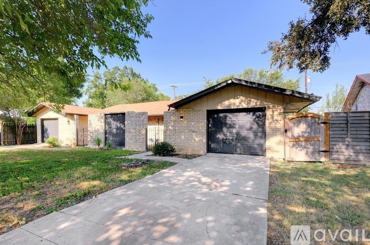 A house with a driveway and garage doors is for sale.
