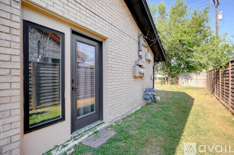 A house with a black door and window is for sale.