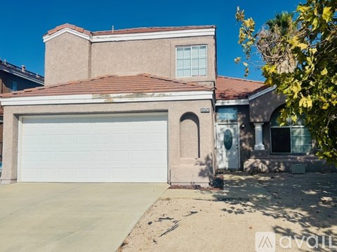 A house with a garage door and a driveway.