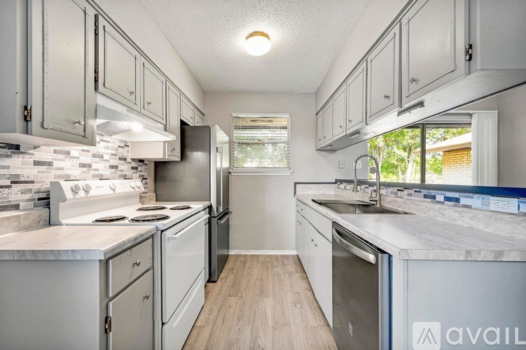 A kitchen with white appliances and cabinets.