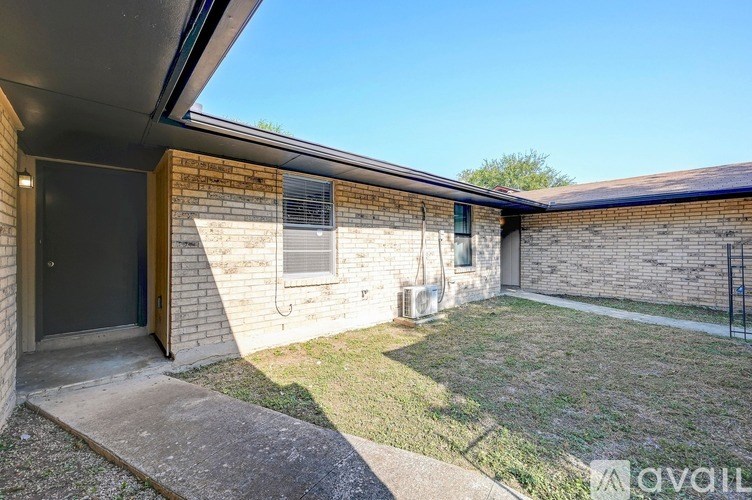 A house with a brick wall and a sliding glass door.