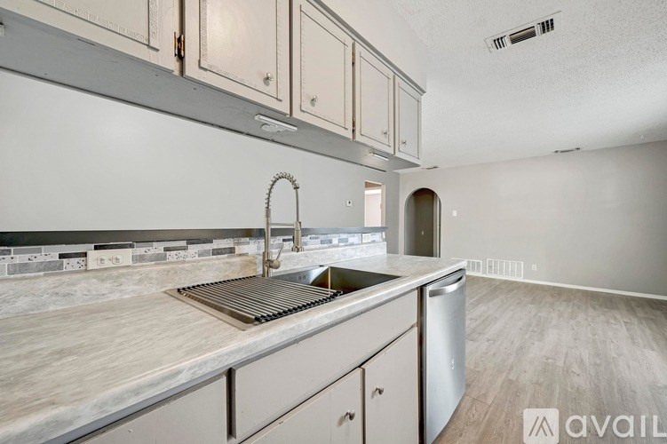 A kitchen with a marble countertop and stainless steel appliances is available for rent.
