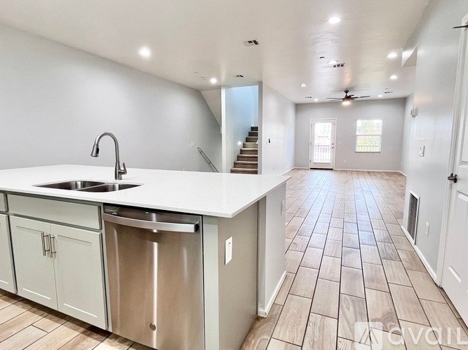 A kitchen with a sink and a stainless steel dishwasher.