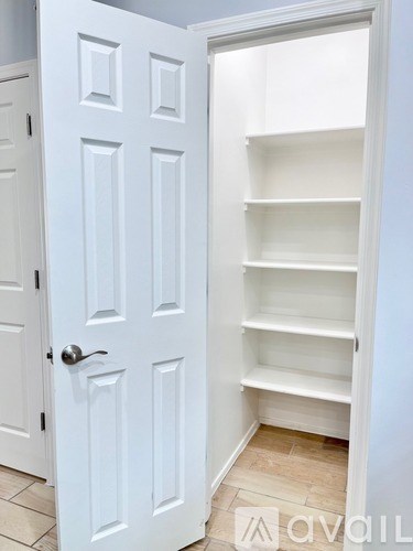 A white door with a shelf on the other side.