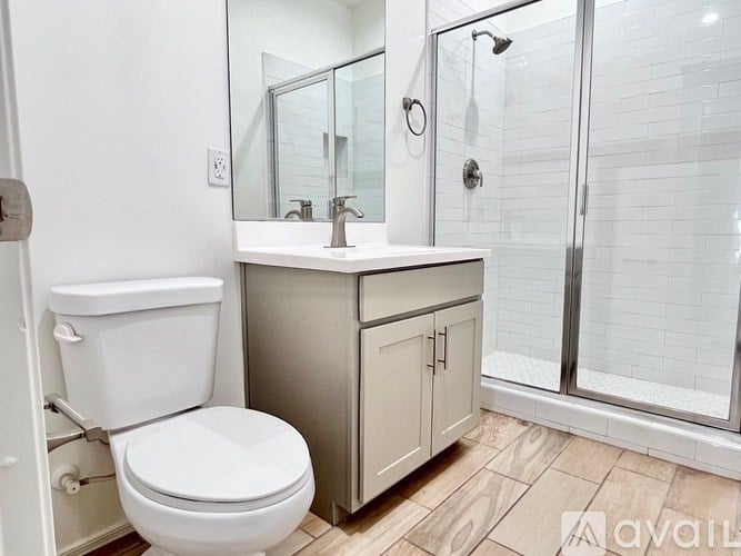A white toilet sits next to a sink in a bathroom.