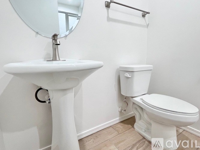 A white sink and toilet in a bathroom.
