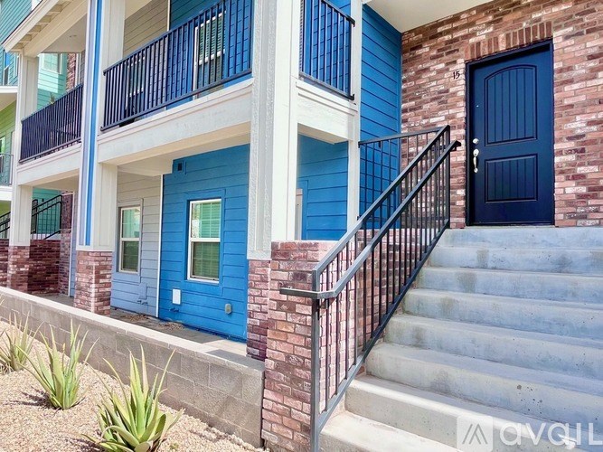 A blue door is on the right side of a building.