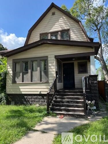 A small house with a front porch and a tree in front.