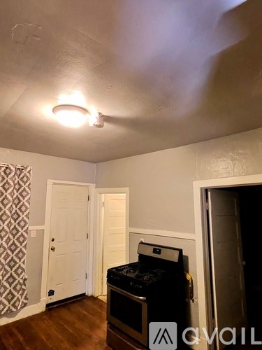 A room with a microwave on top of a counter.