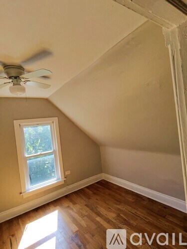 A room with a window and a ceiling fan.
