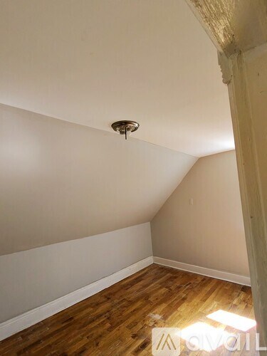 A room with wooden floors and a light on the ceiling.