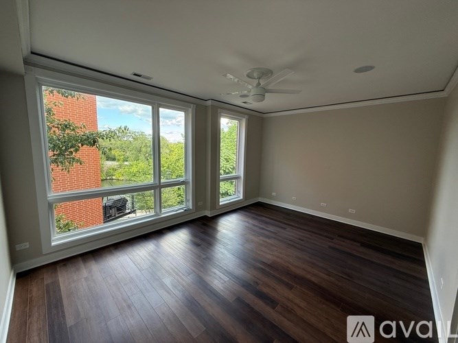 A room with wooden floors and a ceiling fan.