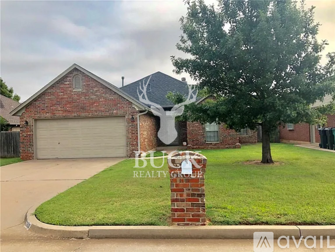 A brick house with a sign that says "Bug Realty" in front of it.