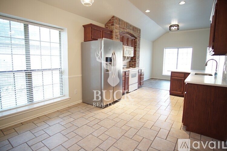 A kitchen with a refrigerator and a counter is available for rent.