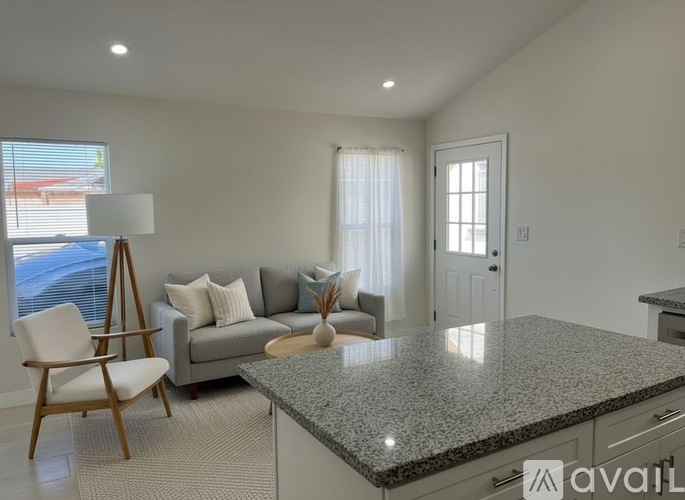 A kitchen with a granite countertop and cabinets.