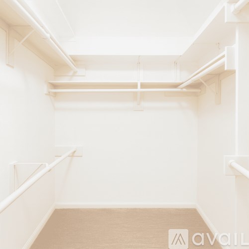 A white room with a wooden floor and white walls.