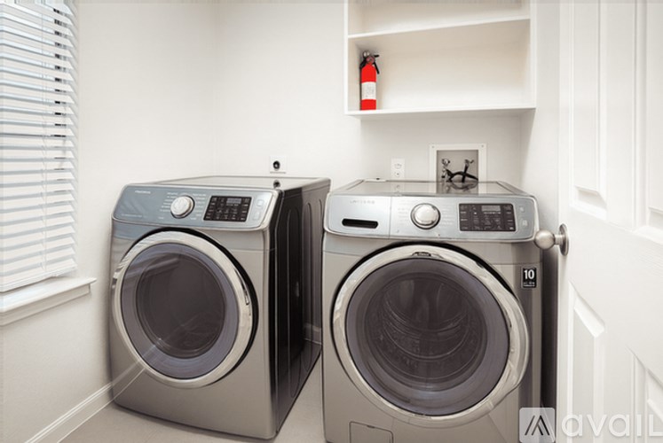 Two front loading washing machines in a laundry room.
