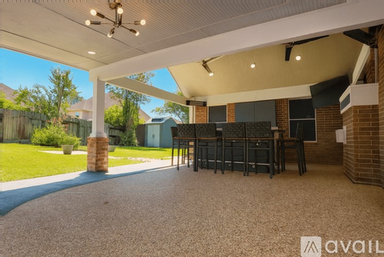 A covered outdoor patio area with a table and chairs.