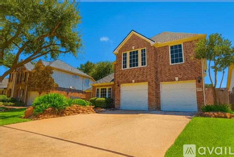 A house with a driveway and garage is available for sale.