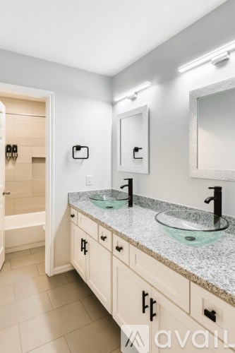 A bathroom with a vanity and a mirror.