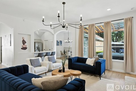 A living room with a dark blue couch and a wooden coffee table.