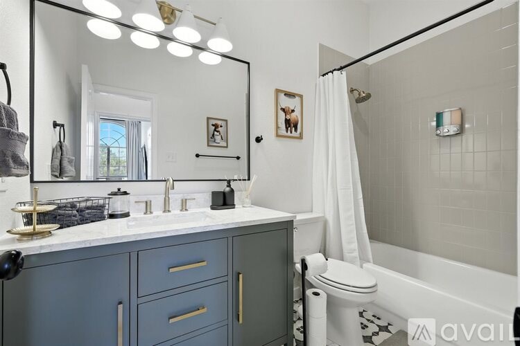 A bathroom with a white sink and a mirror above it.