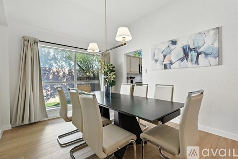 A modern dining room with a large table and chairs.