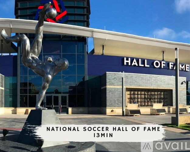A statue of a soccer player in mid-air in front of the National Soccer Hall of Fame.