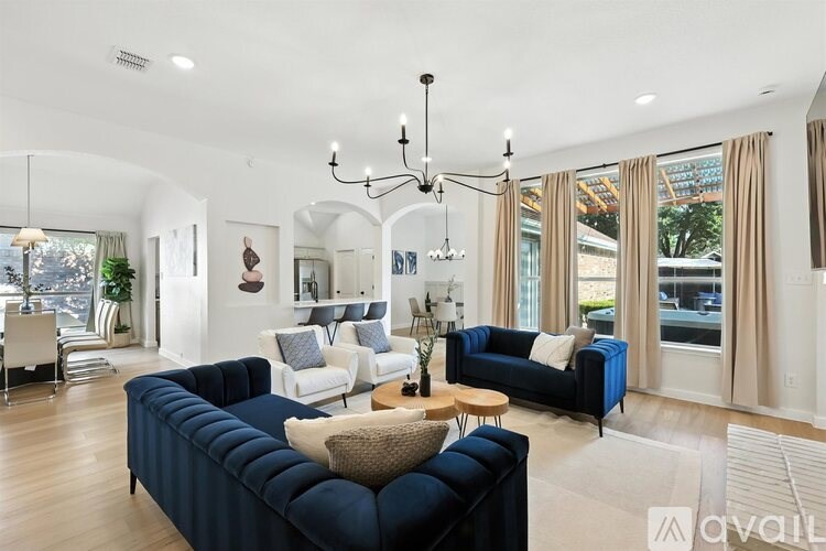 A living room with a dark blue sofa and a wooden coffee table.