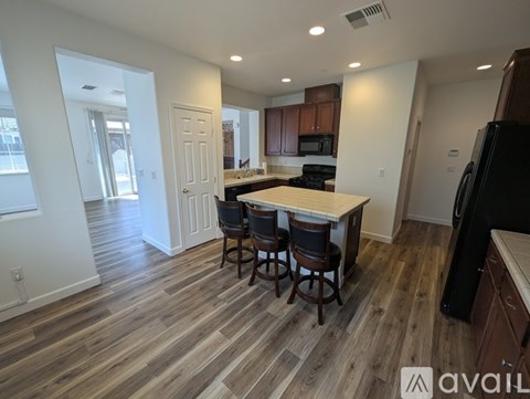 A kitchen with a table and chairs in the middle of the room.