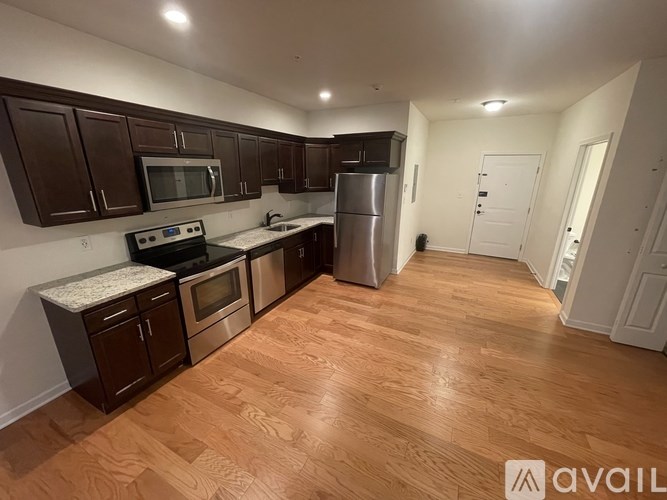 A kitchen with wooden floors and white walls.