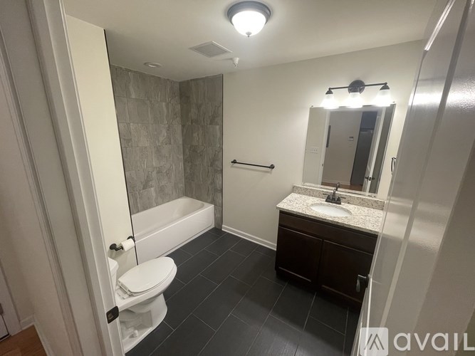 A bathroom with a toilet, sink, and bathtub.