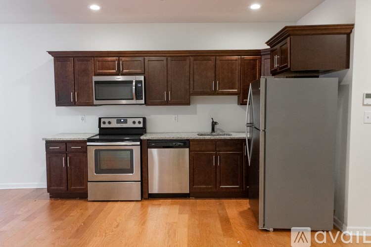 A kitchen with wooden cabinets and stainless steel appliances.