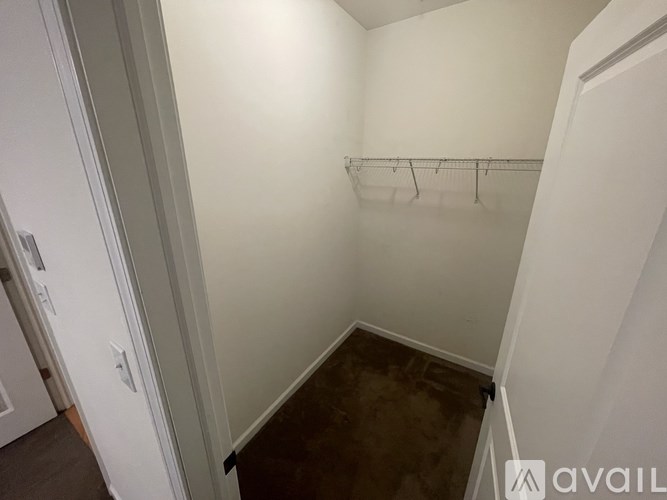 A small, empty room with a metal rack on the wall.