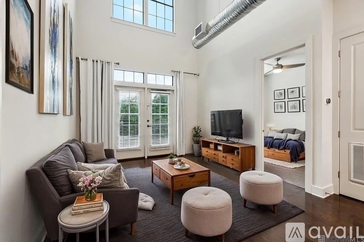A living room with a couch, a coffee table, and a television.