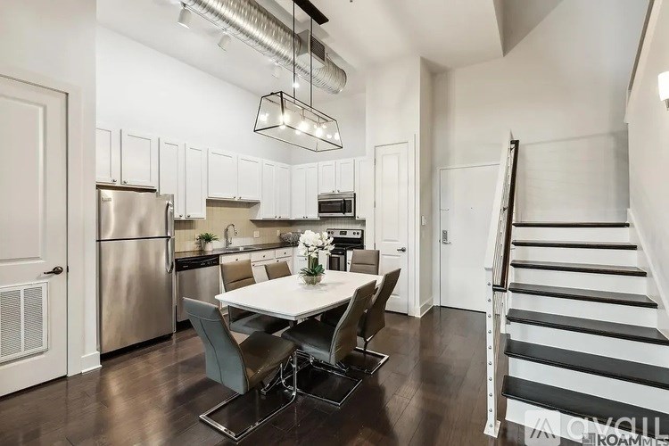 A modern kitchen with a dining table and chairs.