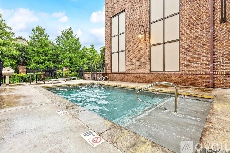 A pool surrounded by a brick wall with a no diving sign.