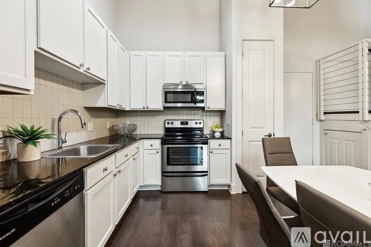 A kitchen with white cabinets and a black stove top oven.