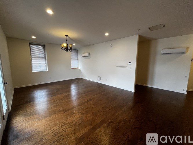 A room with wooden floors and a chandelier.
