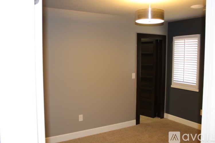 A room with a carpeted floor and a light on the ceiling.