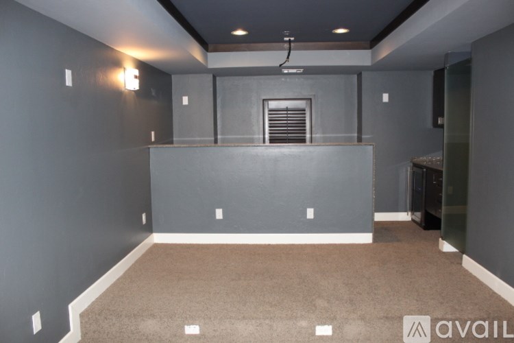 A room with grey walls and a carpeted floor.