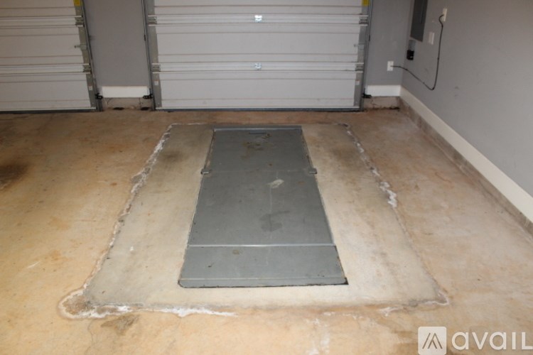 A concrete floor with a metal plate in the middle.