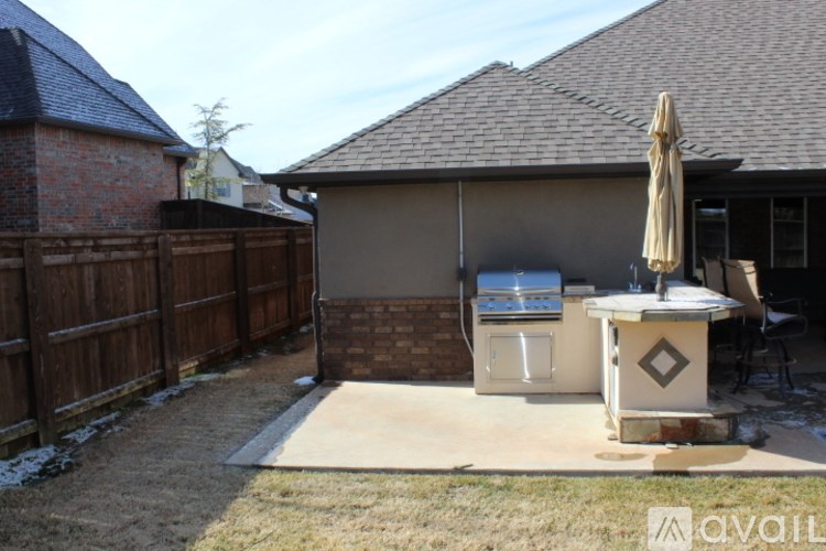 A backyard with a hot tub and a fence.