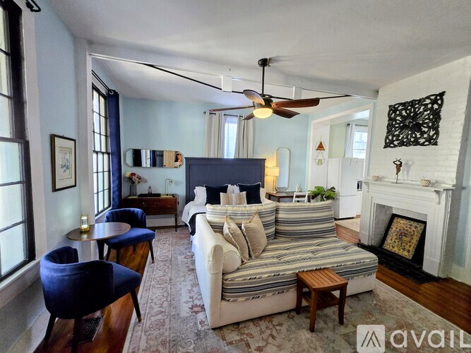 A bedroom with a bed, dresser, and mirror.
