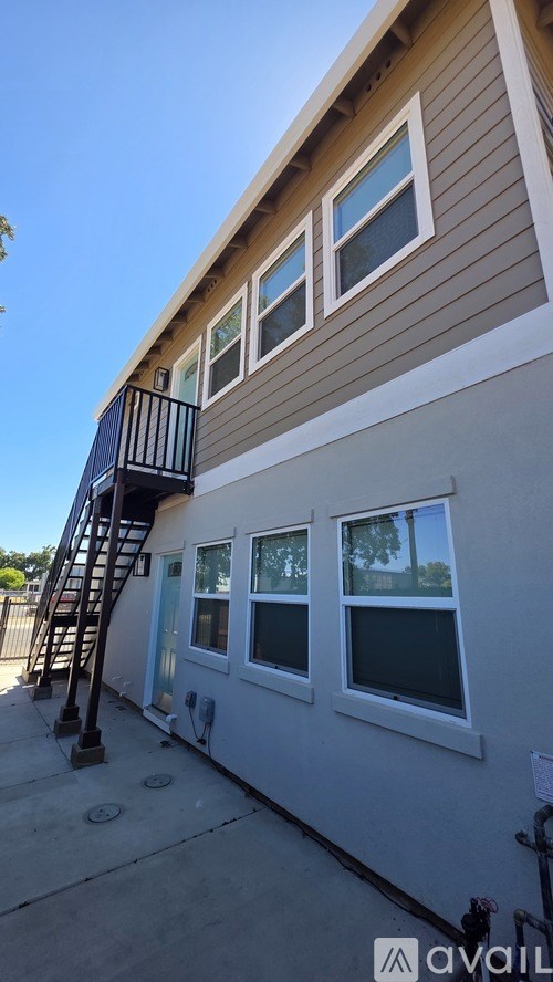 A house with a balcony and a staircase leading to the second floor.
