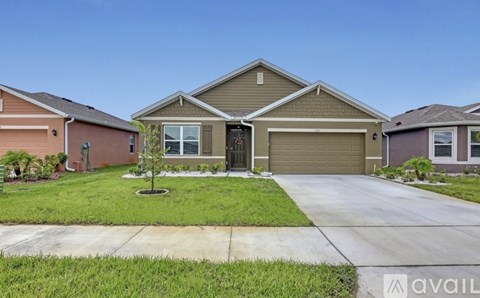 A house with a brown roof and a garage door is available for sale.